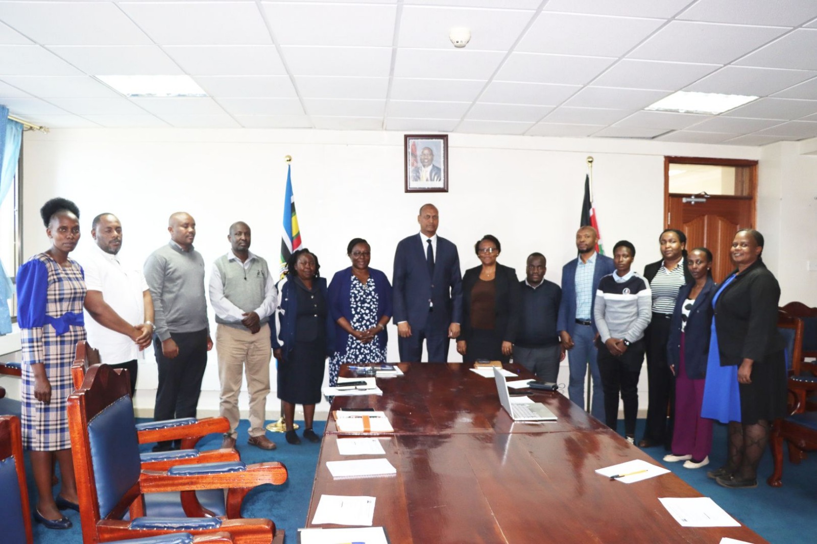 The Principal Secretary for the State Department for Shipping and Maritime Affairs, Mr. Aden Millah, poses for a group photo with staff from the Procurement Department.