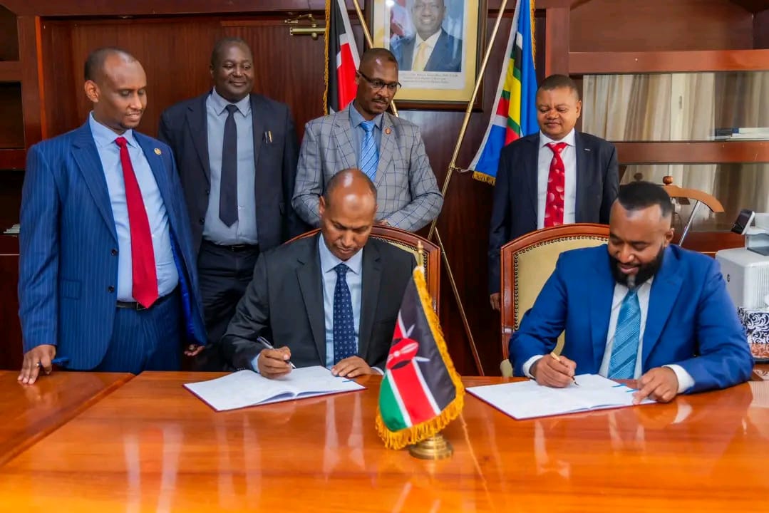 On the right, CS Ali Hassan Joho and on the left, PS Aden Millah during PC Signing.