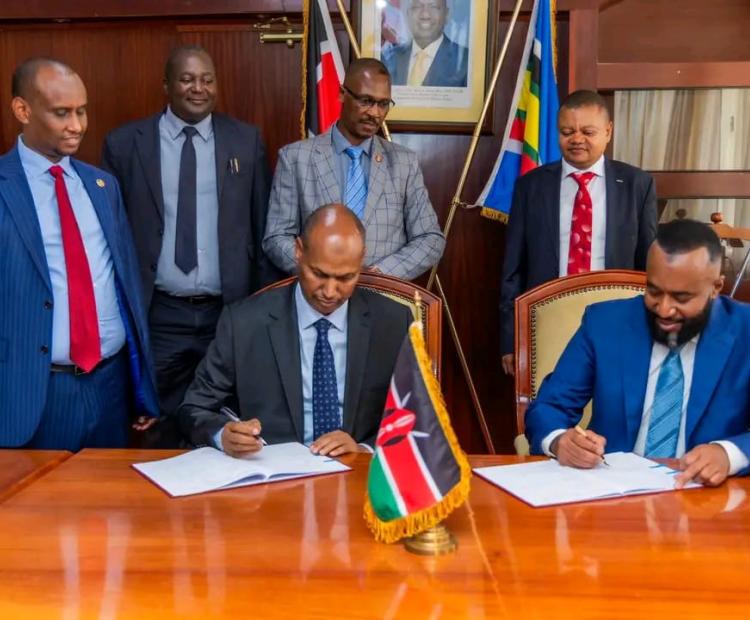 On the right, CS Ali Hassan Joho and on the left, PS Aden Millah during PC Signing.